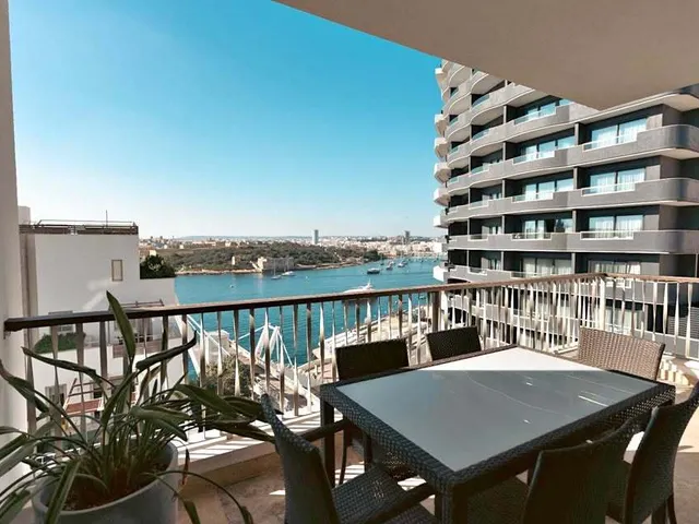 a large patio with a balcony overlooking a city 
