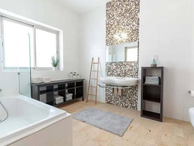 a bathroom with a tub, toilet, sink and shower 
