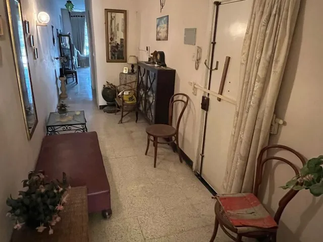 a room with a table, chairs, and a tv