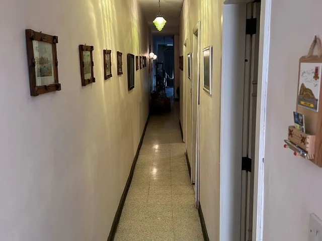 a hallway with a door and a door with a picture on it