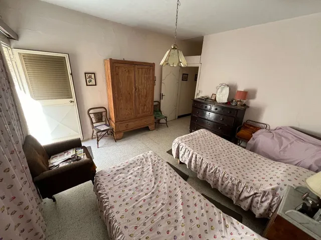 a bedroom with a bed, desk, and a mirror