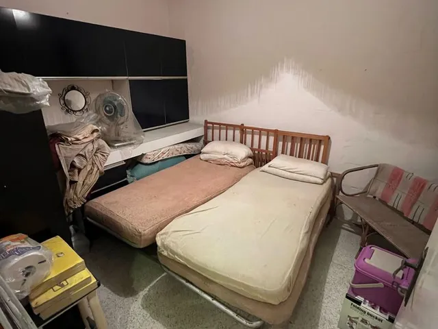 a bed room with a bed, desk, and a chair