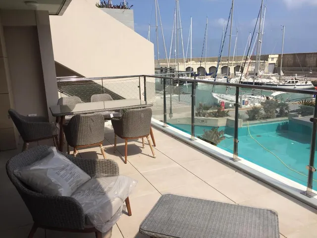 a beach with a balcony and a pool