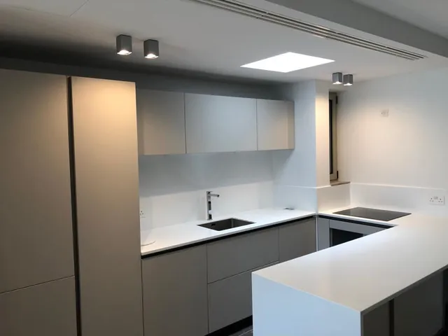 a kitchen with a sink, stove, and refrigerator
