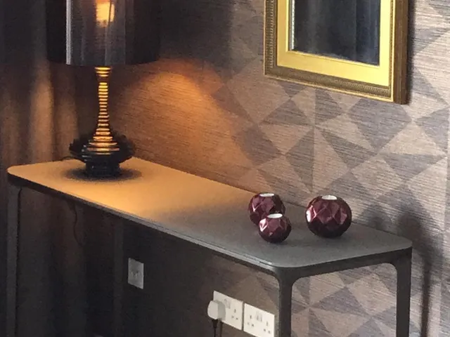 a lamp sitting on top of a wooden table
