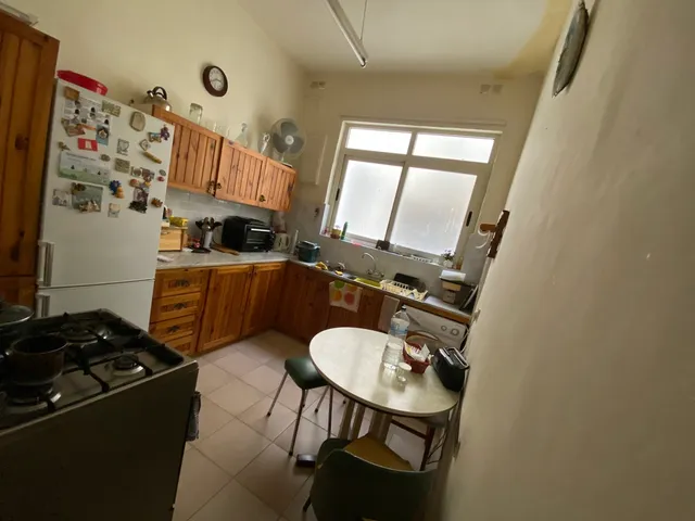 a kitchen with a stove, sink, and refrigerator 