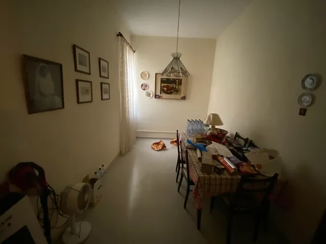 a living room filled with furniture and a table 