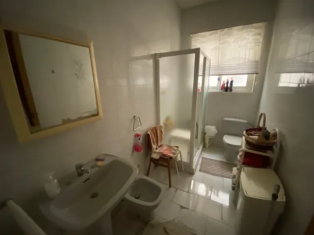 a bathroom with a toilet, sink, and bathtub 
