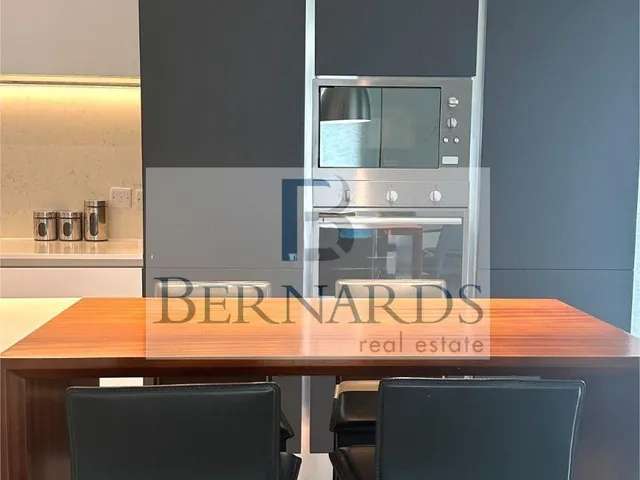a kitchen with a table and a refrigerator