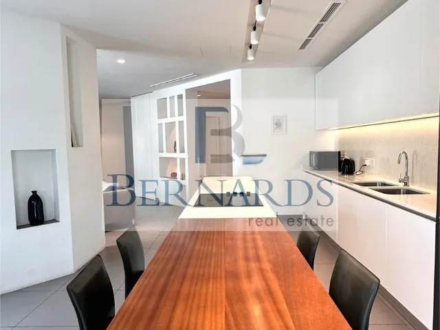 a kitchen with a wooden table and a wooden table top