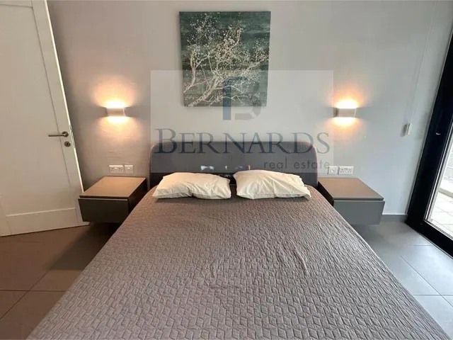 a bed with a white bedspread and a white comforter