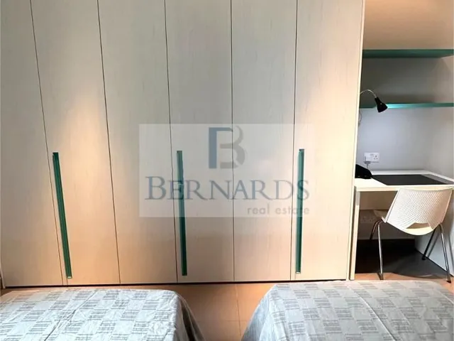 a bathroom with a toilet and a bed