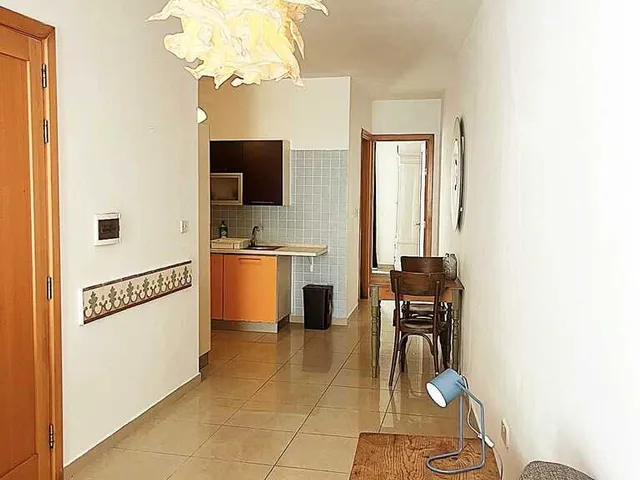 a kitchen with a stove, sink, and refrigerator 