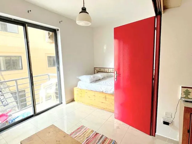 a bedroom with a bed, a window and a bed frame 