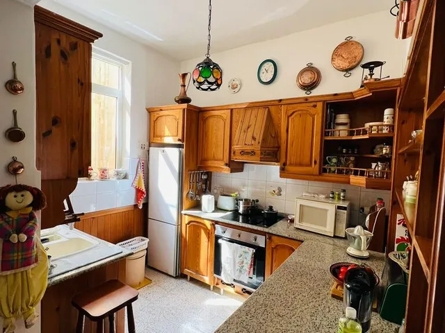 a kitchen with a stove, refrigerator, sink and a dishwasher