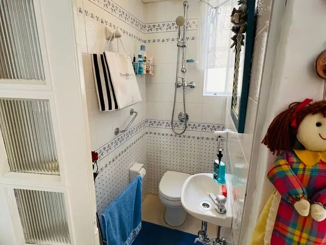 a bathroom with a toilet, sink, and bathtub
