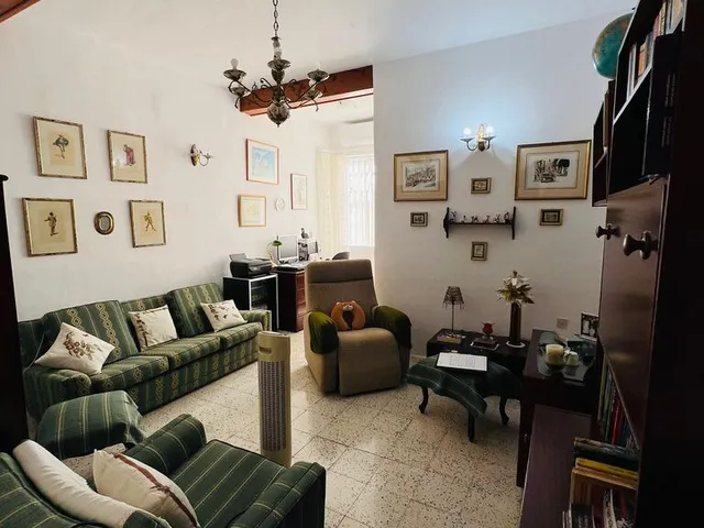 a living room with a couch, coffee table, and a television