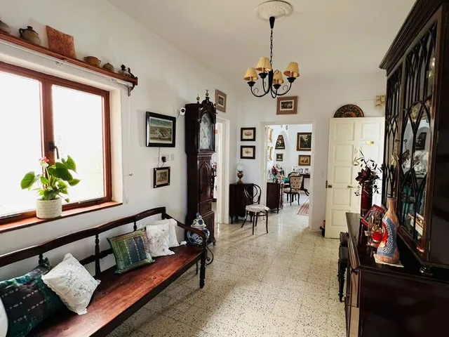 a living room with a couch, chair, and a window