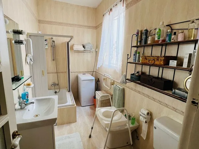 a bathroom with a sink, toilet, and a mirror