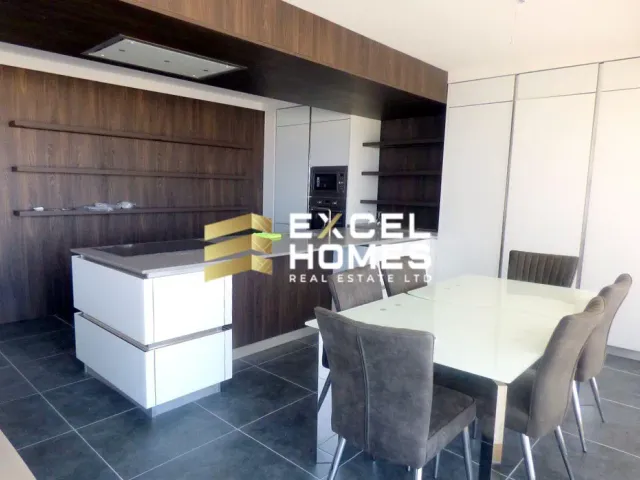 a kitchen with a table and chairs and a refrigerator