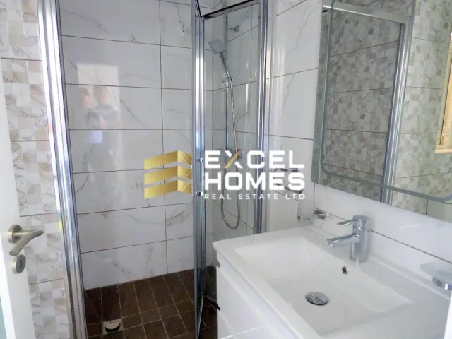 a bathroom with a sink, toilet and shower