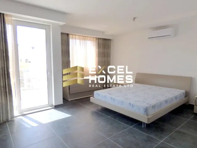 a bedroom with a bed, a dresser and a window