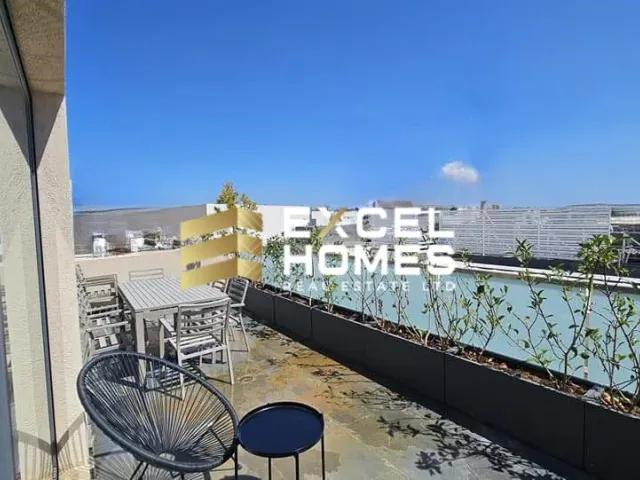 a dining room with a balcony overlooking a city 