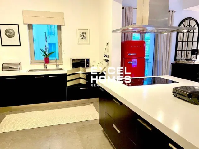 a kitchen with a large window and a large counter top 