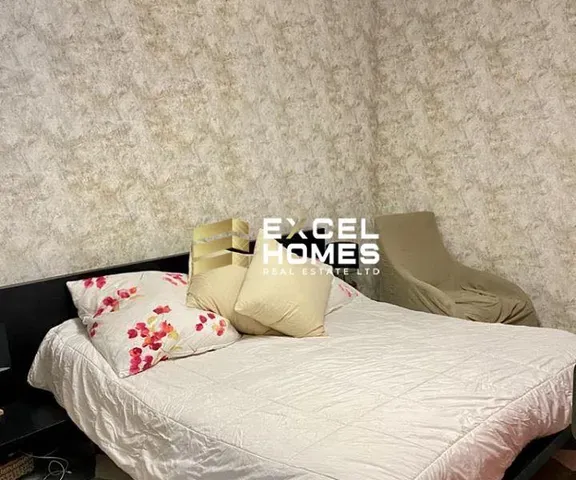 a bed with a white comforter and pillows 