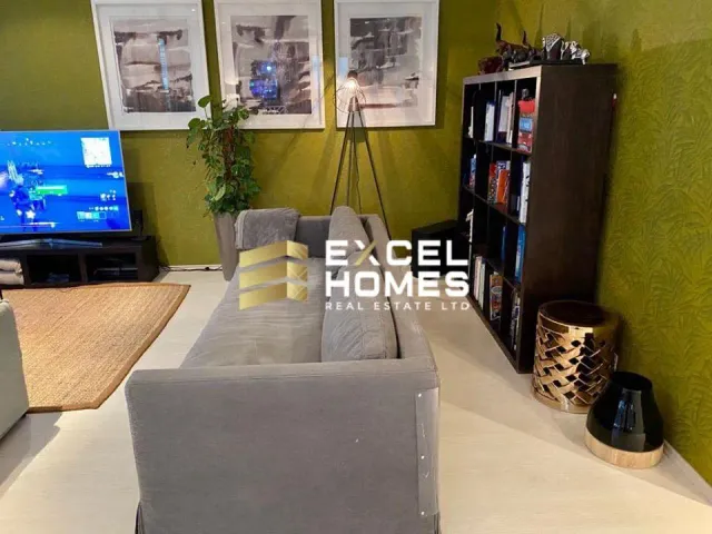 a living room with a couch, coffee table and a television 