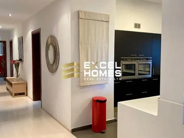 a white refrigerator in a room with a tv 