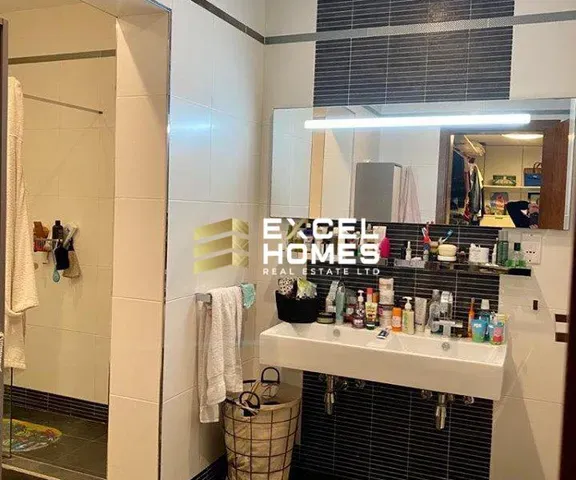 a bathroom with a sink, mirror, and a bathtub 