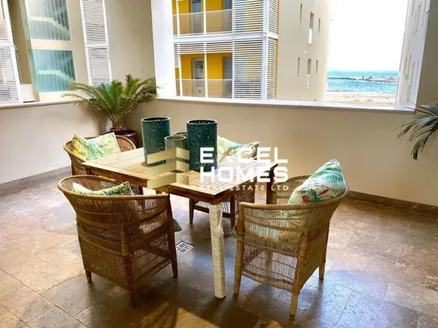 a table with chairs and a table cloth 