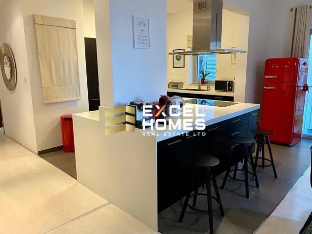 a kitchen with a sink, refrigerator, and counter top 