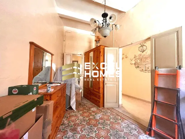 a kitchen with a refrigerator, sink, and a door 