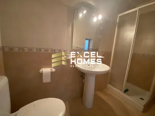 a bathroom with a toilet, sink, and shower 