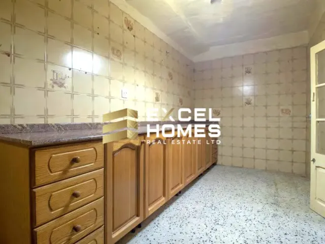 a kitchen with a sink, a cabinet and a mirror 