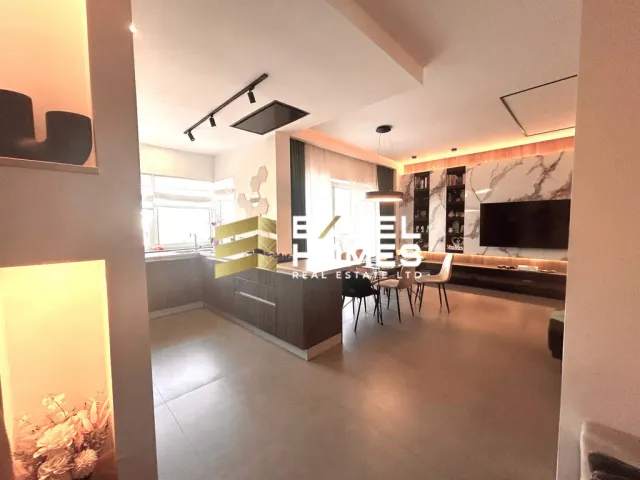 a living room with a couch, table, chairs and a television