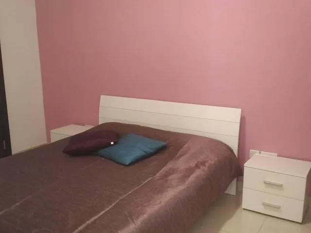 a bed with a blue blanket and a blue pillow 