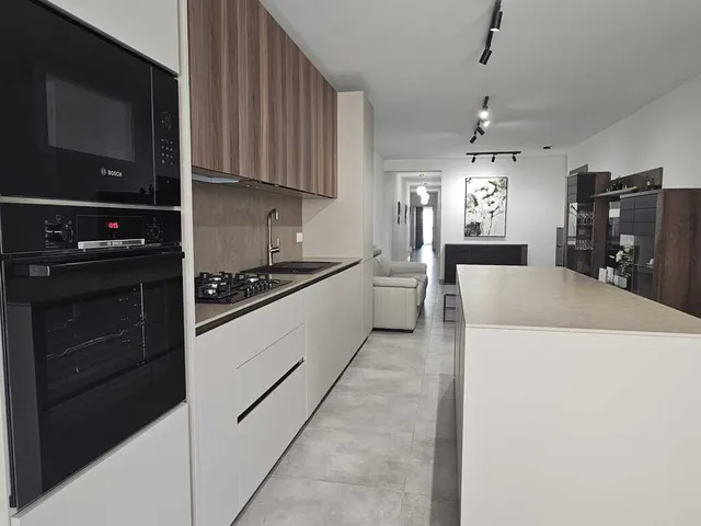 a kitchen with a stove, refrigerator, sink and microwave