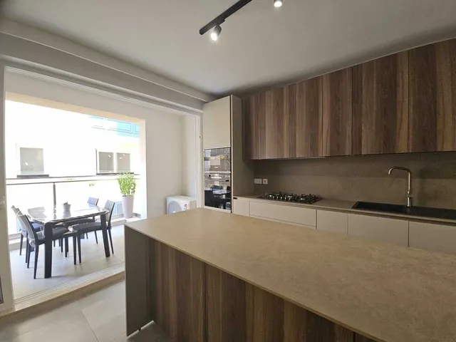 a kitchen with a stove, sink, and refrigerator