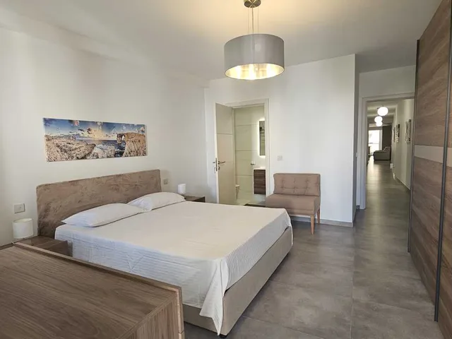 a hotel room with a bed, a lamp, and a wall mounted wall mounted wall mounted wall mounted wall mounted wall mounted wall mounted wall mounted wall mounted wall mounted wall mounted wall mounted wall mounted wall mounted wall mounted wall mounted wall mounted wall mounted wall mounted