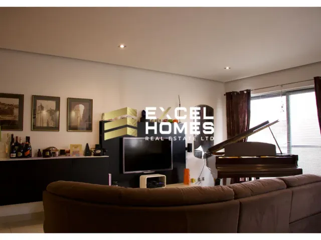 a living room with a piano and a couch