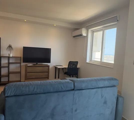 a living room with a couch, chair, and television