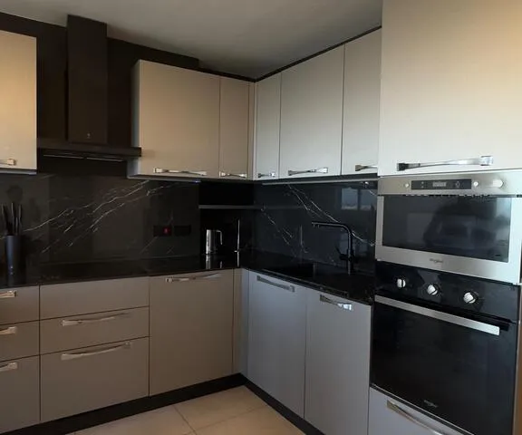 a kitchen with a stove, microwave, and dishwasher