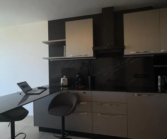 a kitchen with a sink, microwave, and a refrigerator