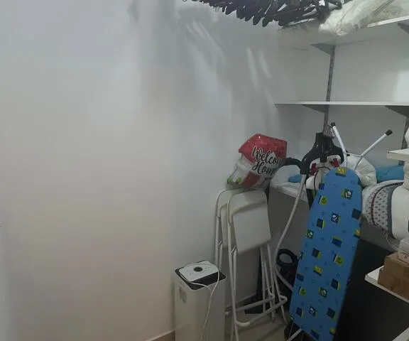 a room with a bunch of clothes on the floor