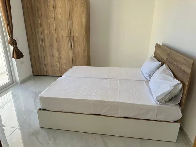 a bed with a white bedspread and a white pillow 