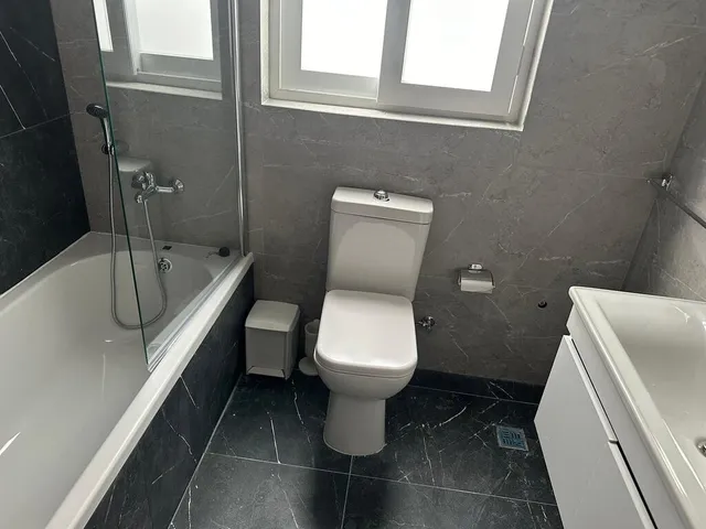 a bathroom with a toilet, sink, tub and shower 