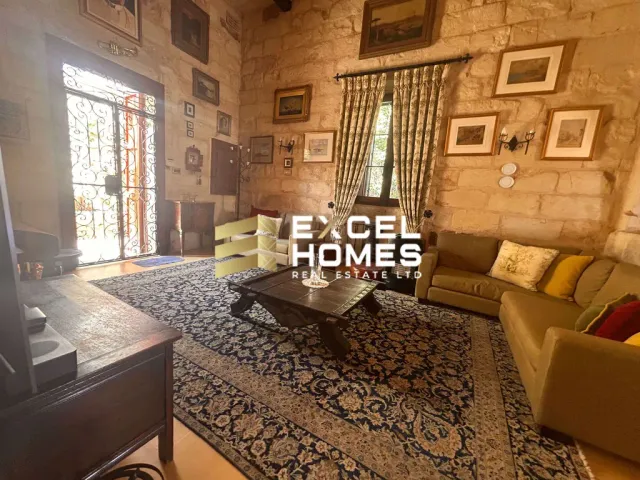 a living room with a large window and a large rug